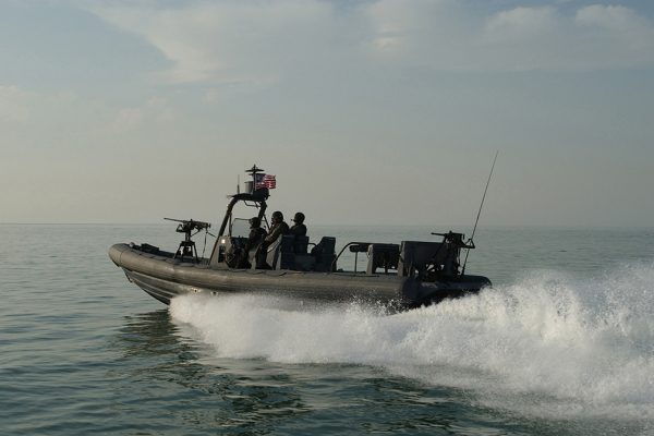 030218-N-5362A-009
Central Command Area of Responsibility (Feb. 18, 2003) -- Naval Special Warfare combatant-craft crewmen operate a Rigid Hull Inflatable Boat (RHIB) from a forward location.  A RHIB is a high-speed, high- buoyancy, extreme-weather craft assigned the primary mission of ship-to-shore insertion/extraction of SEAL tactical elements.  U.S. Navy photo by Photographer's Mate 1st Class Arlo K. Abrahamson.  (RELEASED)